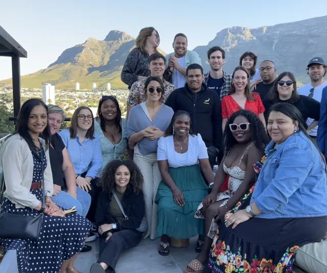 A cohort gathered in front of Table Mountain